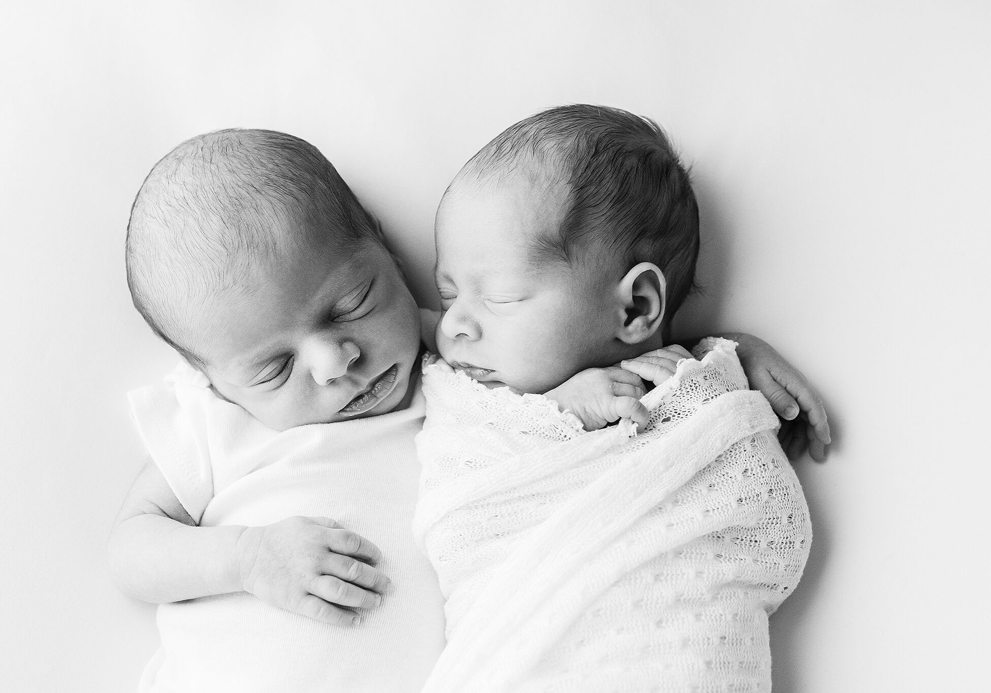 Newborn Photographer Madison. Sleepy newborn twins snuggle.